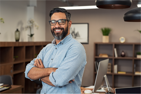 Person standing in an office smiling