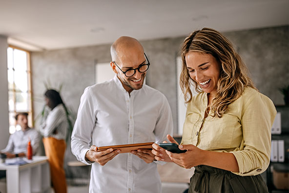 Two people looking at devices