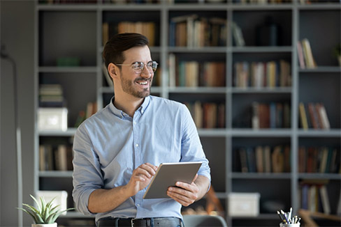 Person standing holding a notepad